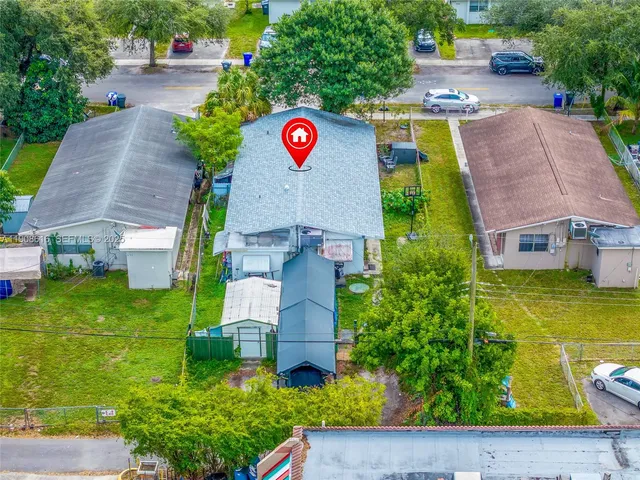 an aerial view of a house with yard