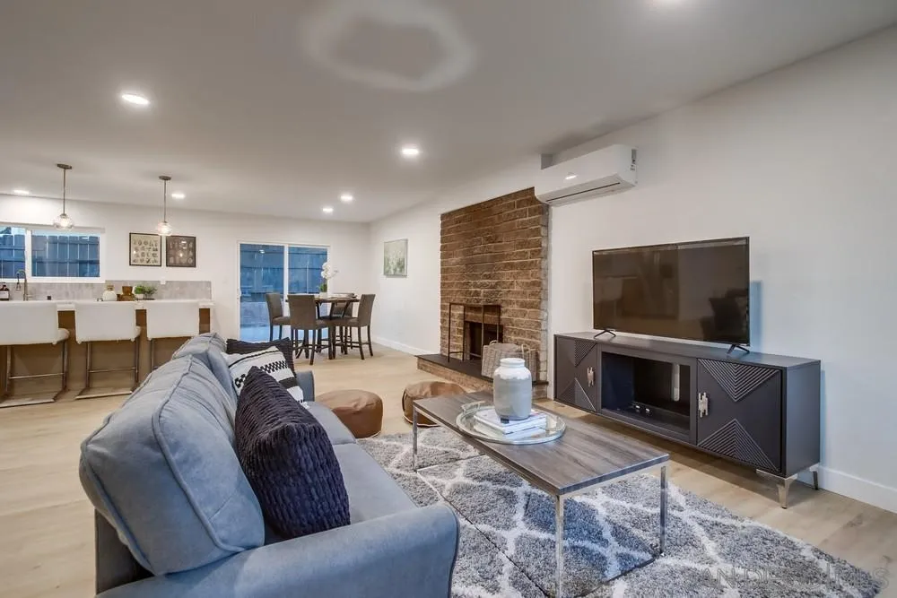 12378 Wade Way El Cajon, CA 92021 - Photo 14 of 48 a living room with furniture a flat screen tv and a fireplace