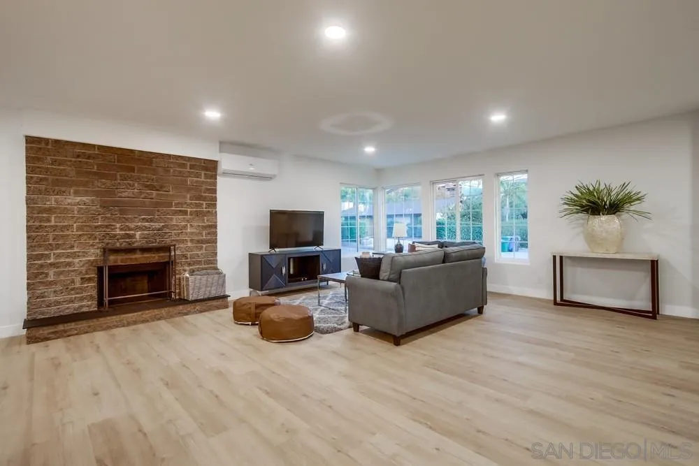 12378 Wade Way El Cajon, CA 92021 - Photo 17 of 48 a living room with furniture a fireplace a flat screen tv and a fireplace