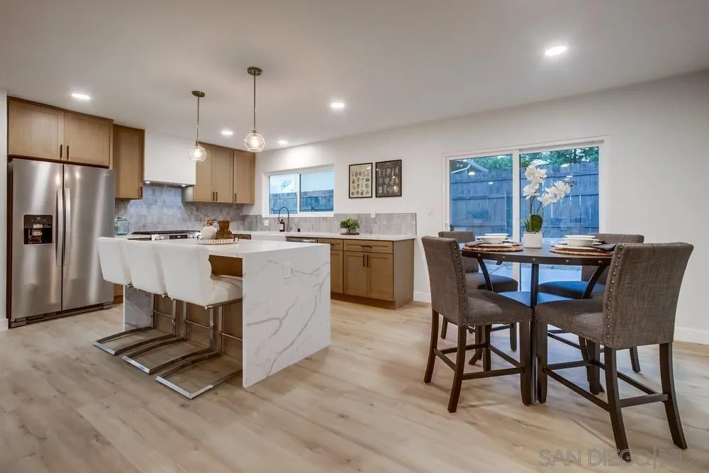 12378 Wade Way El Cajon, CA 92021 - Photo 18 of 48 a kitchen with kitchen island a dining table and chairs
