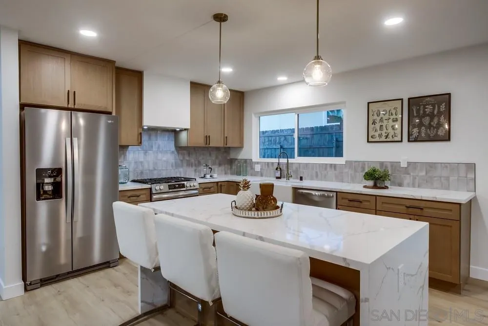 12378 Wade Way El Cajon, CA 92021 - Photo 21 of 48 a kitchen with a refrigerator a sink a stove and chairs
