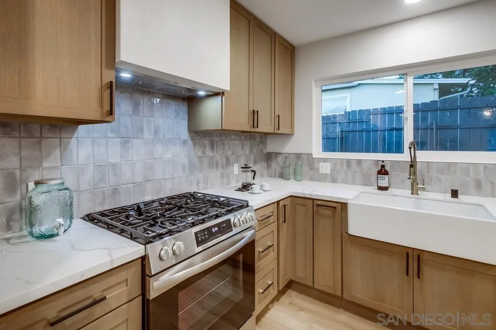 12378 Wade Way El Cajon, CA 92021 - Photo 23 of 48 a kitchen with a sink a stove and cabinets