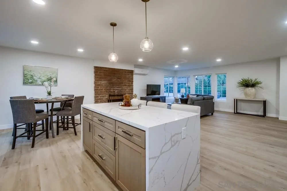 12378 Wade Way El Cajon, CA 92021 - Photo 24 of 48 a large kitchen with kitchen island a island a sink a counter space and stainless steel appliances