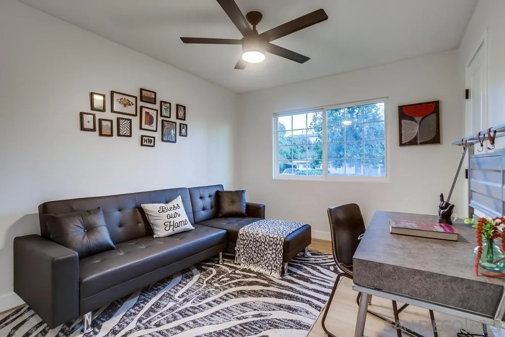 12378 Wade Way El Cajon, CA 92021 - Photo 27 of 48 a living room with furniture a desk and chair with wooden floor