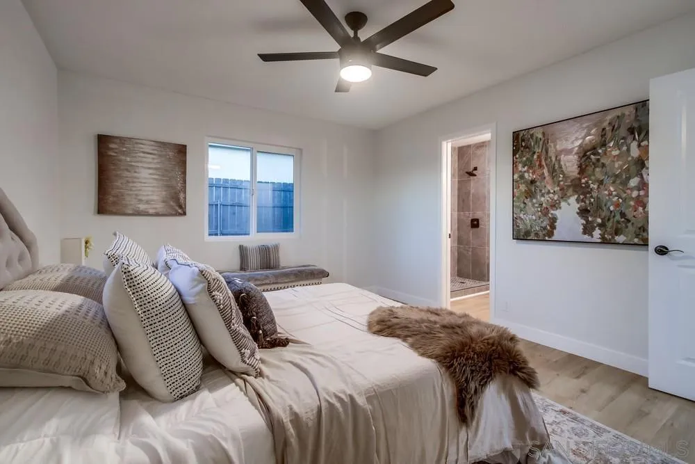 12378 Wade Way El Cajon, CA 92021 - Photo 35 of 48 a bedroom with a large bed and a window