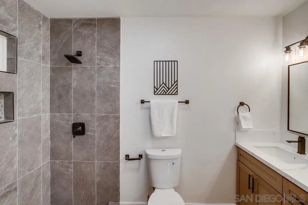 12378 Wade Way El Cajon, CA 92021 - Photo 37 of 48 a bathroom with a shower toilet and sink