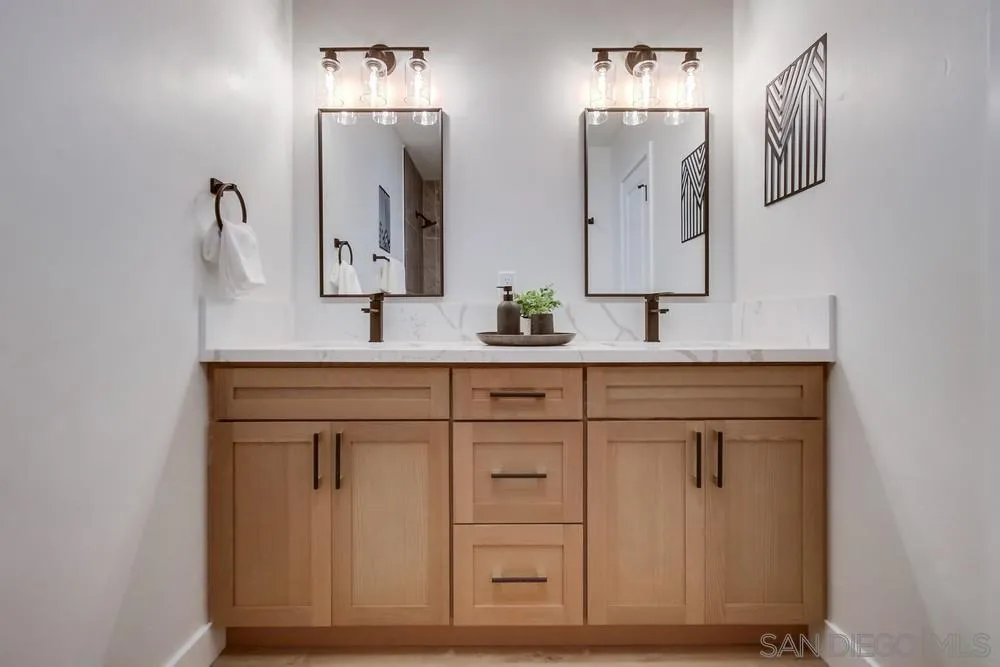 12378 Wade Way El Cajon, CA 92021 - Photo 39 of 48 a bathroom with a double vanity sink and a mirror