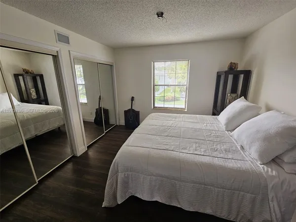 a bedroom with a bed and a mirror