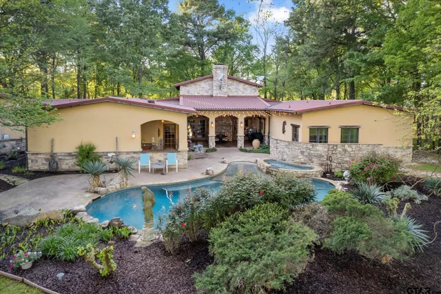 a front view of a house with yard patio and green space