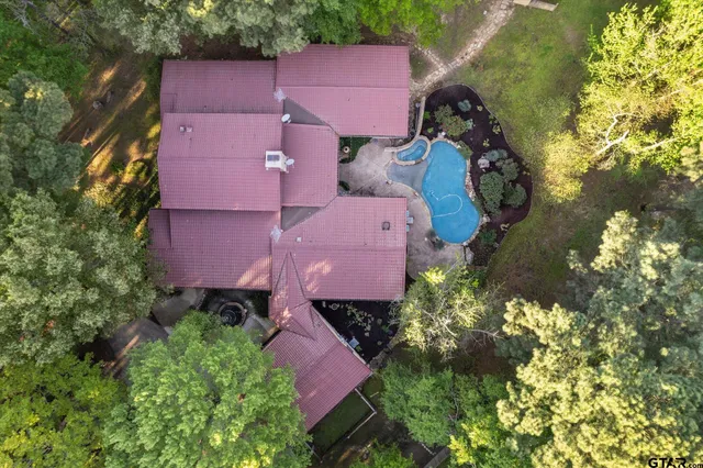an aerial view of a house with a yard and garden