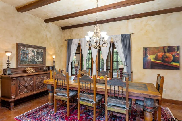 a view of a dining room with furniture and chandelier