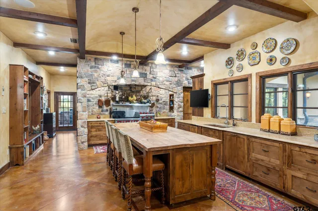 a large kitchen with lots of counter space and stainless steel appliances