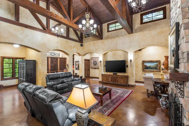 a living room with furniture a fireplace and a flat screen tv