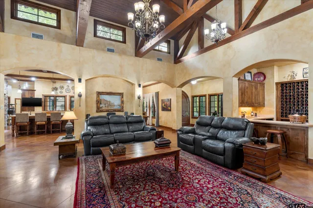 a living room with furniture fireplace and a chandelier