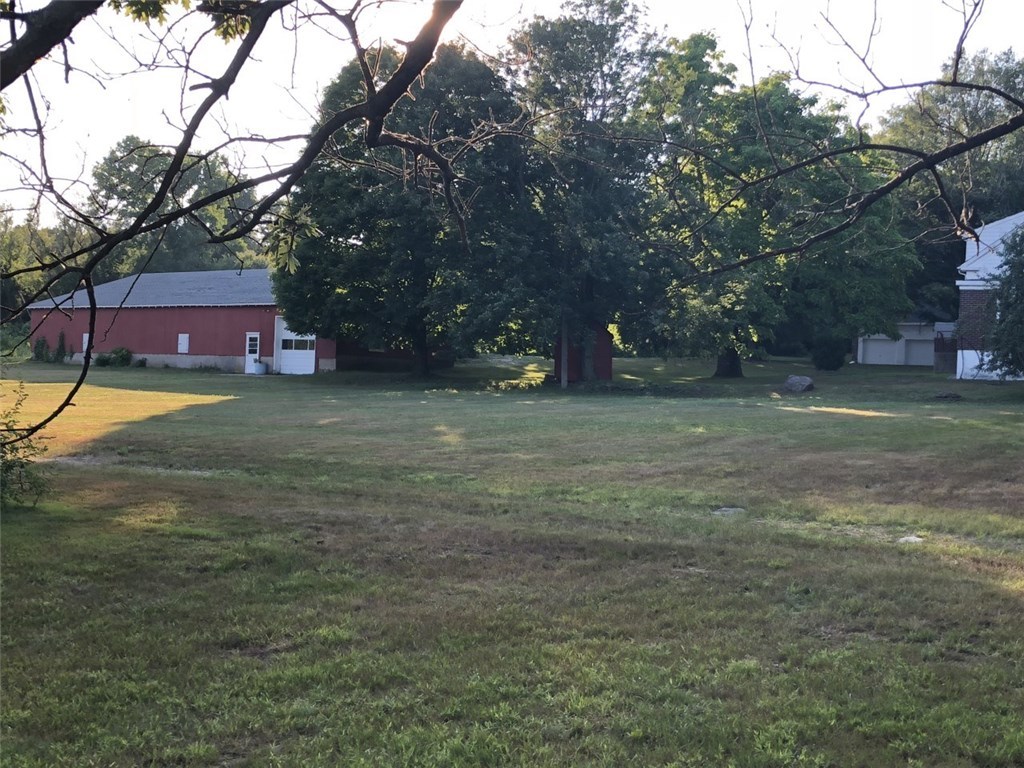 90 Swan Road Smithfield, RI 02917 - Photo 8 of 11 back yard view between the barn/storage and the farm house