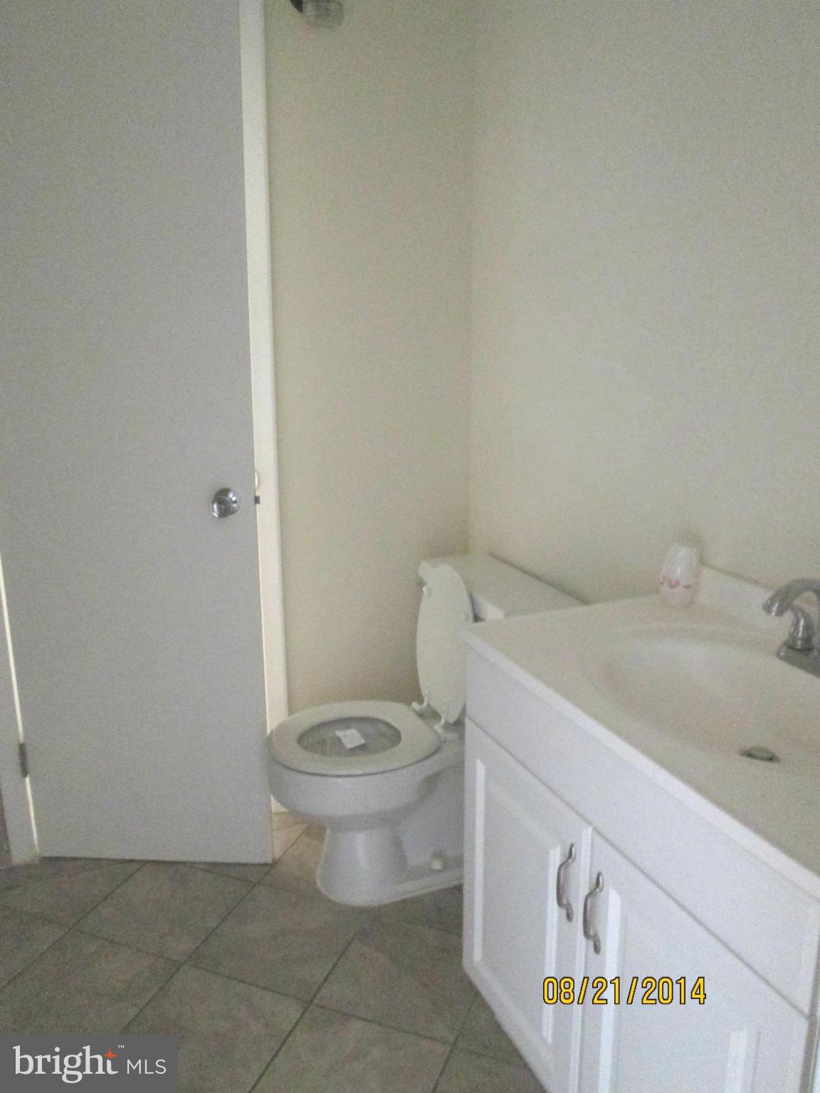 416 Falling Spring Court Reisterstown, MD 21136 - Photo 13 of 16 a white toilet sitting next to a bathroom sink