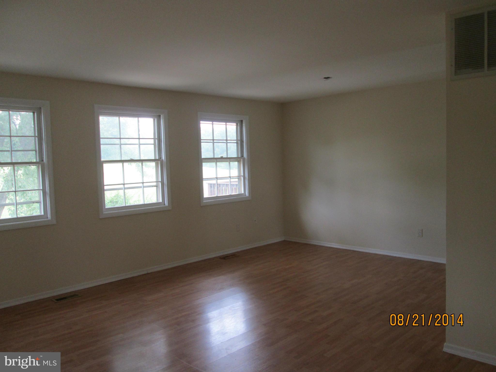 416 Falling Spring Court Reisterstown, MD 21136 - Photo 5 of 16 a view of an empty room with wooden floor and a window