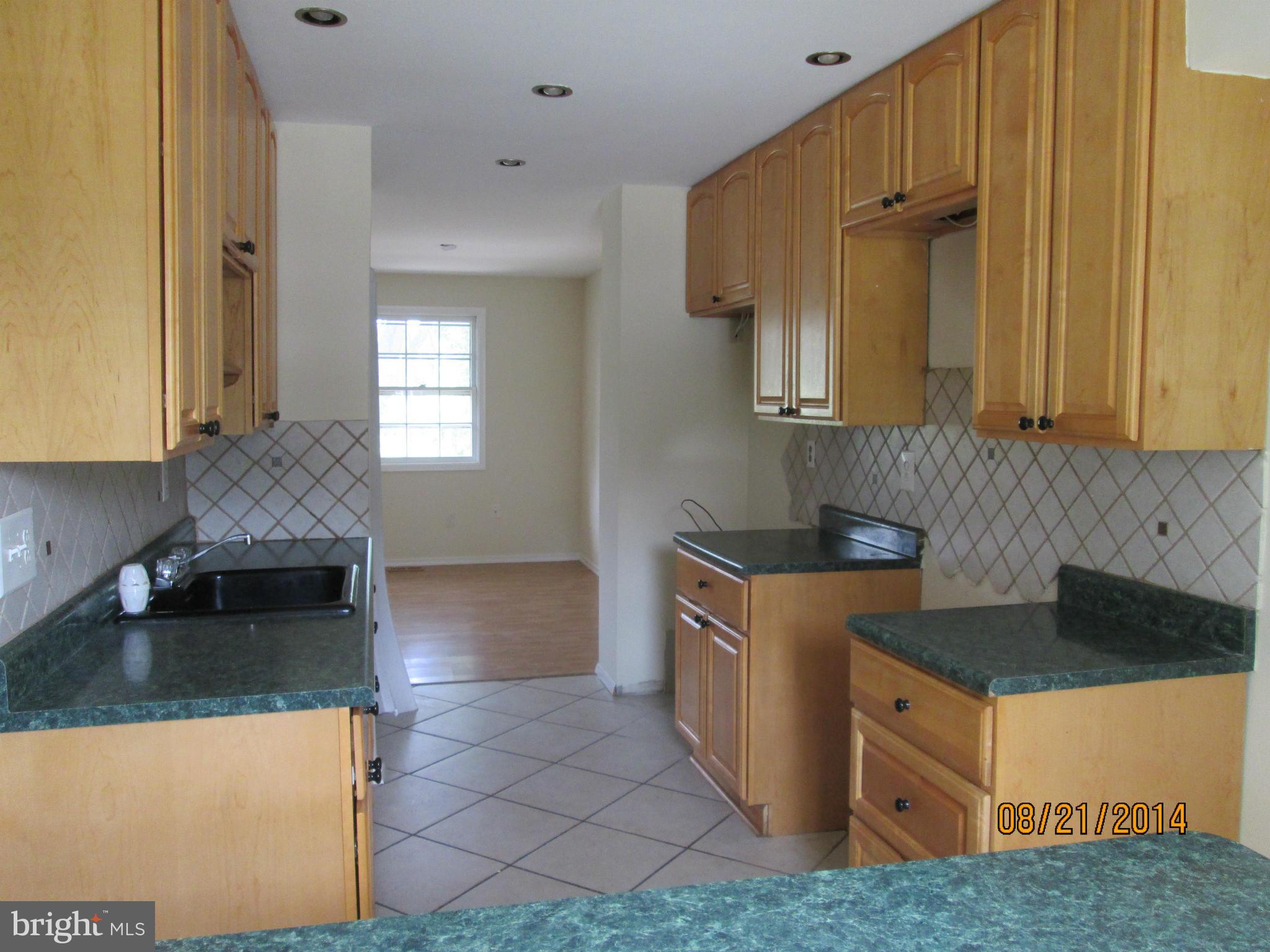416 Falling Spring Court Reisterstown, MD 21136 - Photo 6 of 16 a kitchen with stainless steel appliances granite countertop a sink a stove and a refrigerator