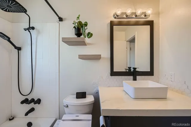 a bathroom with a sink toilet and shower