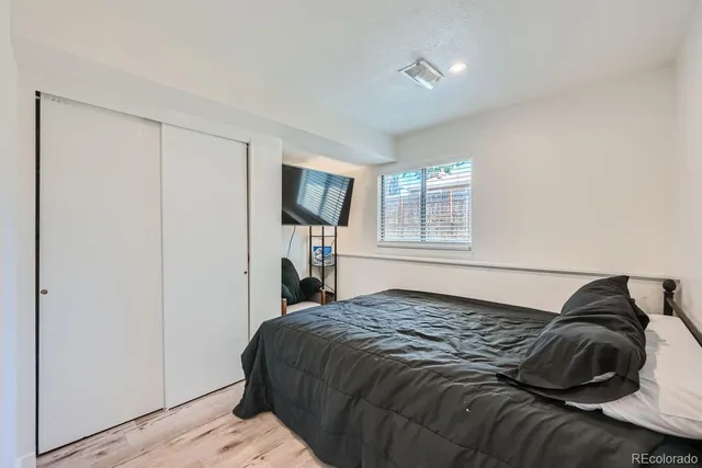 a bedroom with a bed and flat screen tv