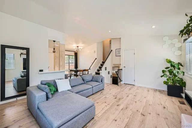 a living room with furniture and flowers