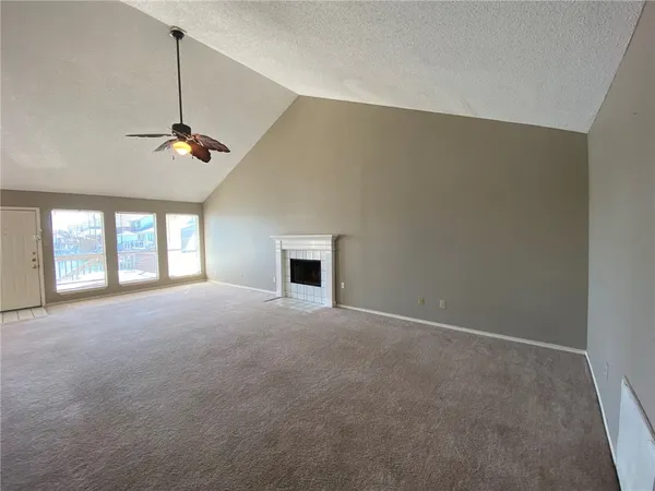 a view of a livingroom with a ceiling fan and window