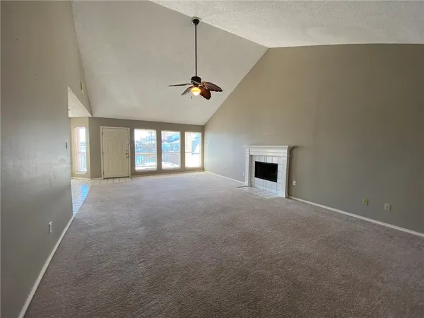 a view of a room with windows and fireplace