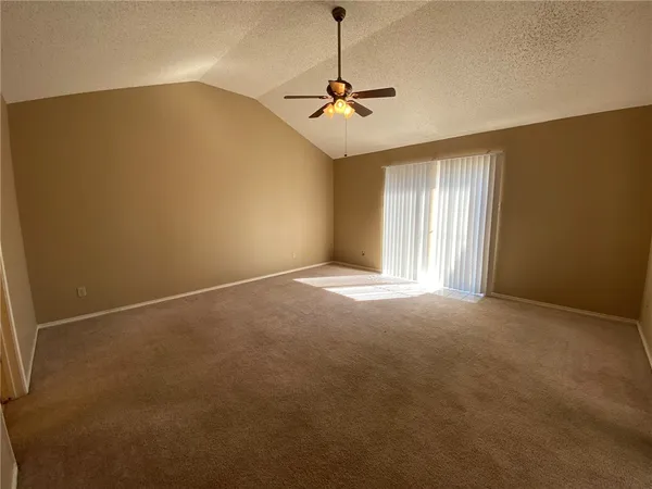 a view of a livingroom with a ceiling fan and window