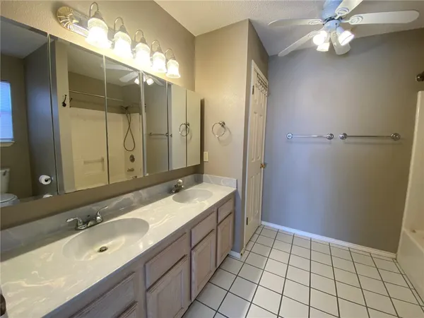 a bathroom with a sink double vanity and a mirror