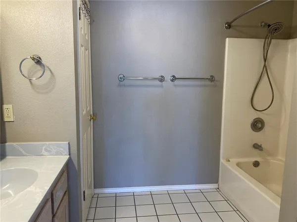 a bathroom with a granite countertop sink a mirror a vanity and a shower