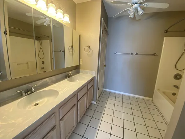 a bathroom with a sink a mirror and a shower