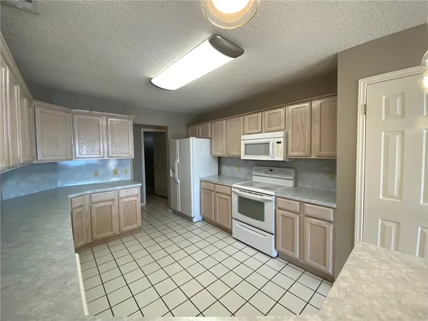 a kitchen with a stove top oven sink and cabinets