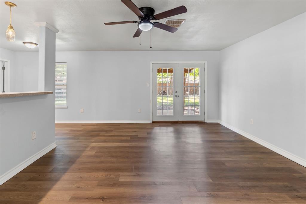 741 Southwest 9th Street Cooper, TX 75432 - Photo 18 of 36 a view of an empty room with window and wooden floor