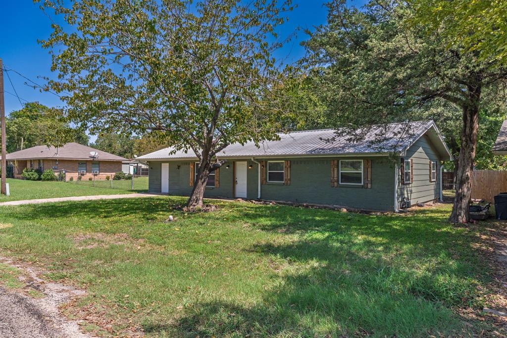 741 Southwest 9th Street Cooper, TX 75432 - Photo 2 of 36 a view of a yard in front of a house with large trees