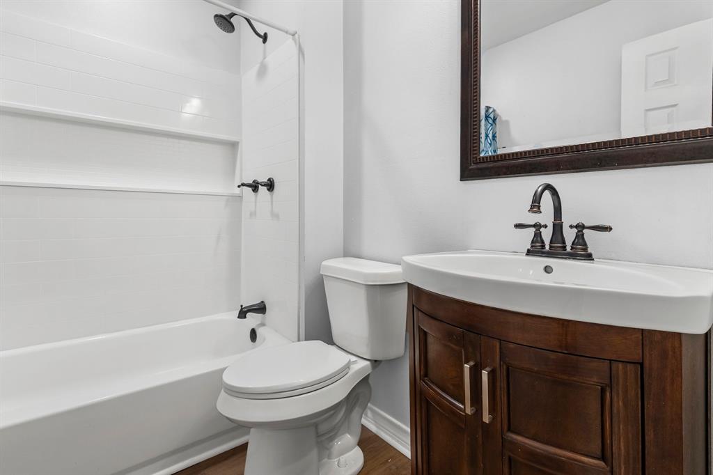 741 Southwest 9th Street Cooper, TX 75432 - Photo 21 of 36 a bathroom with a sink a toilet and shower