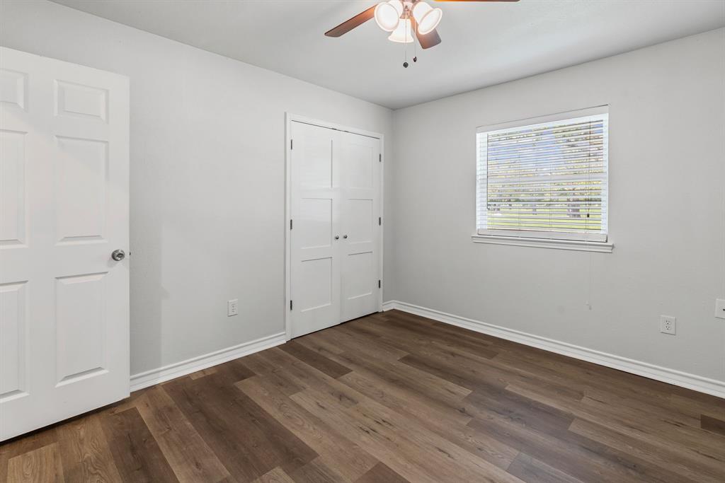 741 Southwest 9th Street Cooper, TX 75432 - Photo 23 of 36 wooden floor in an empty room with a window