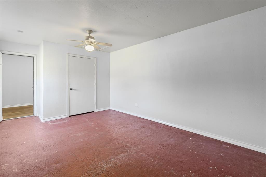 741 Southwest 9th Street Cooper, TX 75432 - Photo 30 of 36 an empty room with a chandelier fan and windows