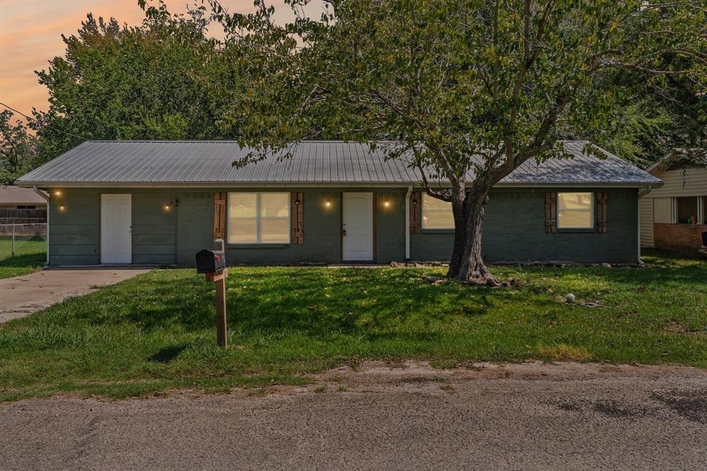 741 Southwest 9th Street Cooper, TX 75432 - Photo 35 of 36 a front view of a house with a garden