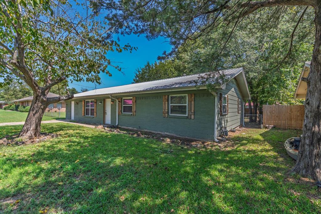741 Southwest 9th Street Cooper, TX 75432 - Photo 4 of 36 a view of a house with a yard
