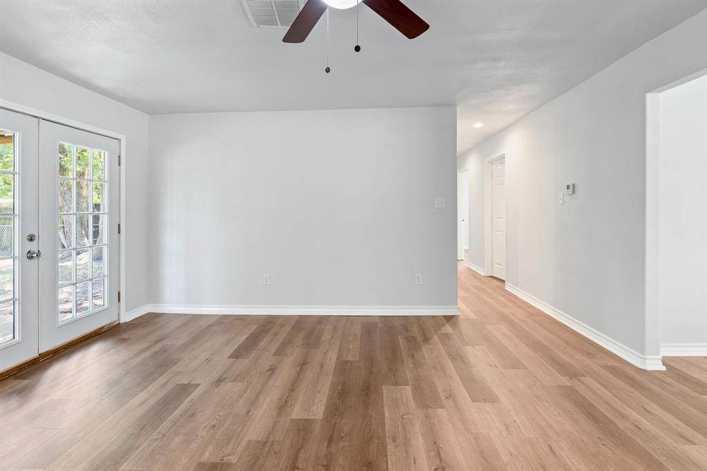 741 Southwest 9th Street Cooper, TX 75432 - Photo 10 of 36 wooden floor in an empty room with a window