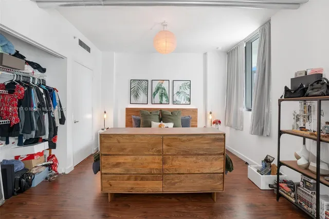 a view of a bedroom with baby bed and a window