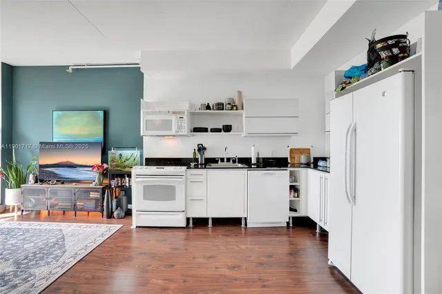 a kitchen with stainless steel appliances a refrigerator and a stove top oven