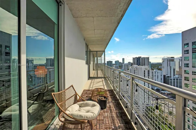 a balcony with table and chairs