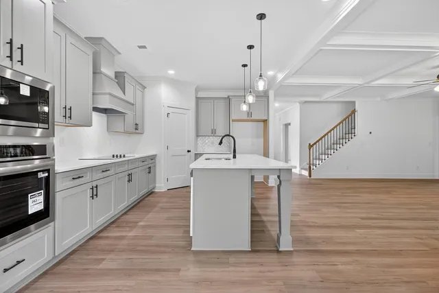 a view of a room with window wooden floor and front door