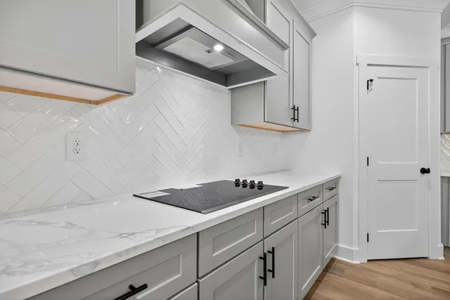 a view of a kitchen with wooden floor and a view of kitchen