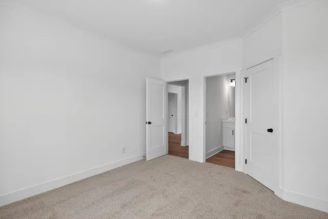 a view of a hallway with wooden floor and closet