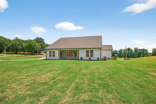 a front view of a residential apartment building with a yard