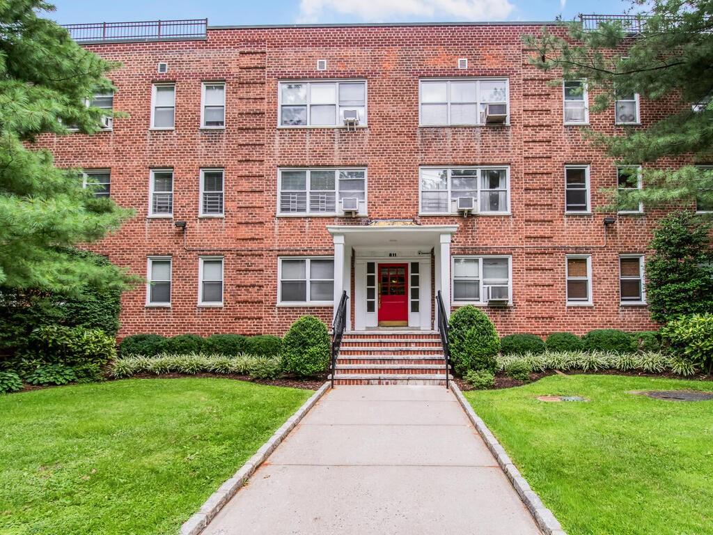 811 Palmer Road, Unit 3B Bronxville, NY 10708 - Photo 1 of 1 View of front of property with cooling unit and a front lawn