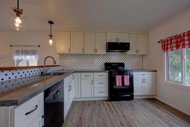 a kitchen with a sink stove and cabinets