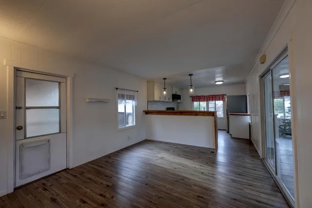 a view of a kitchen with a sink and refrigerator